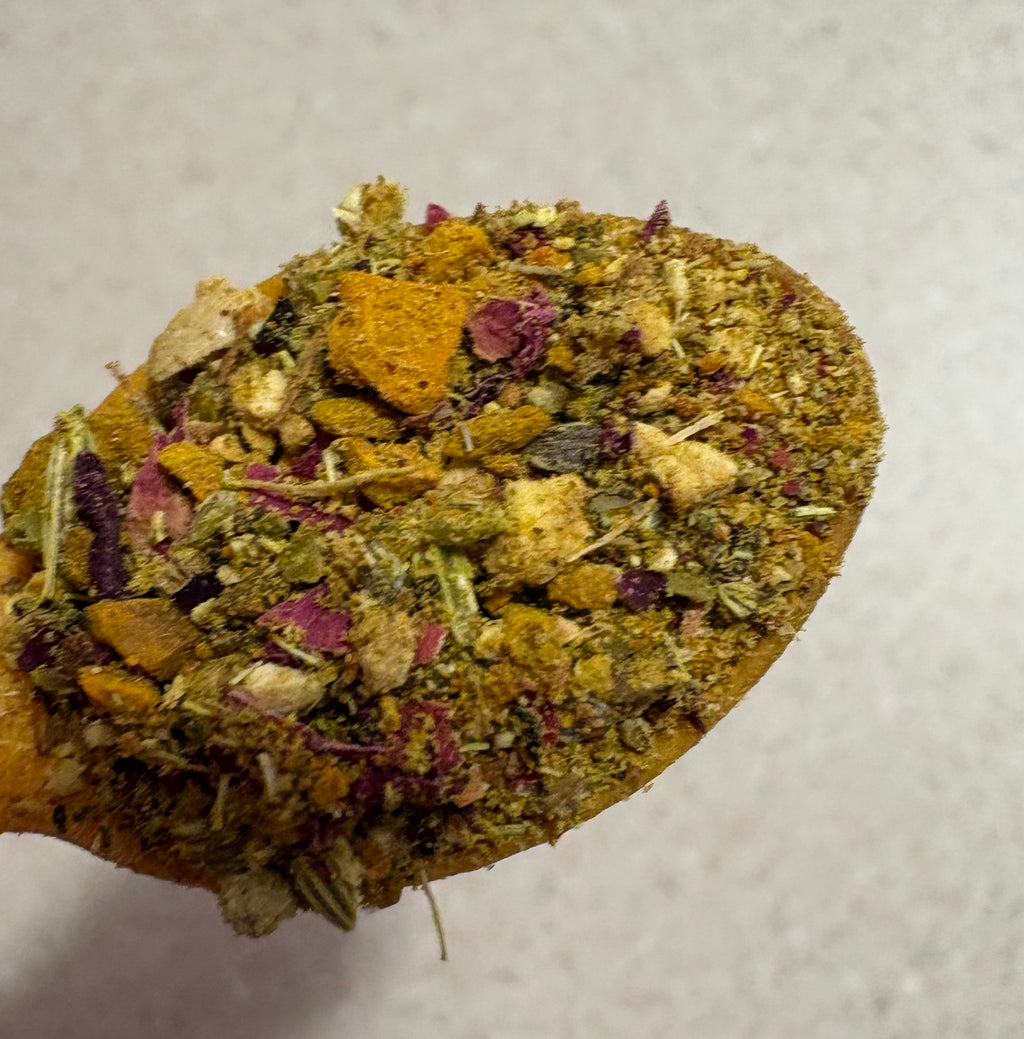 Spoonful of Mehra Cup caffeine-free turmeric tea blend with rose petals and botanicals