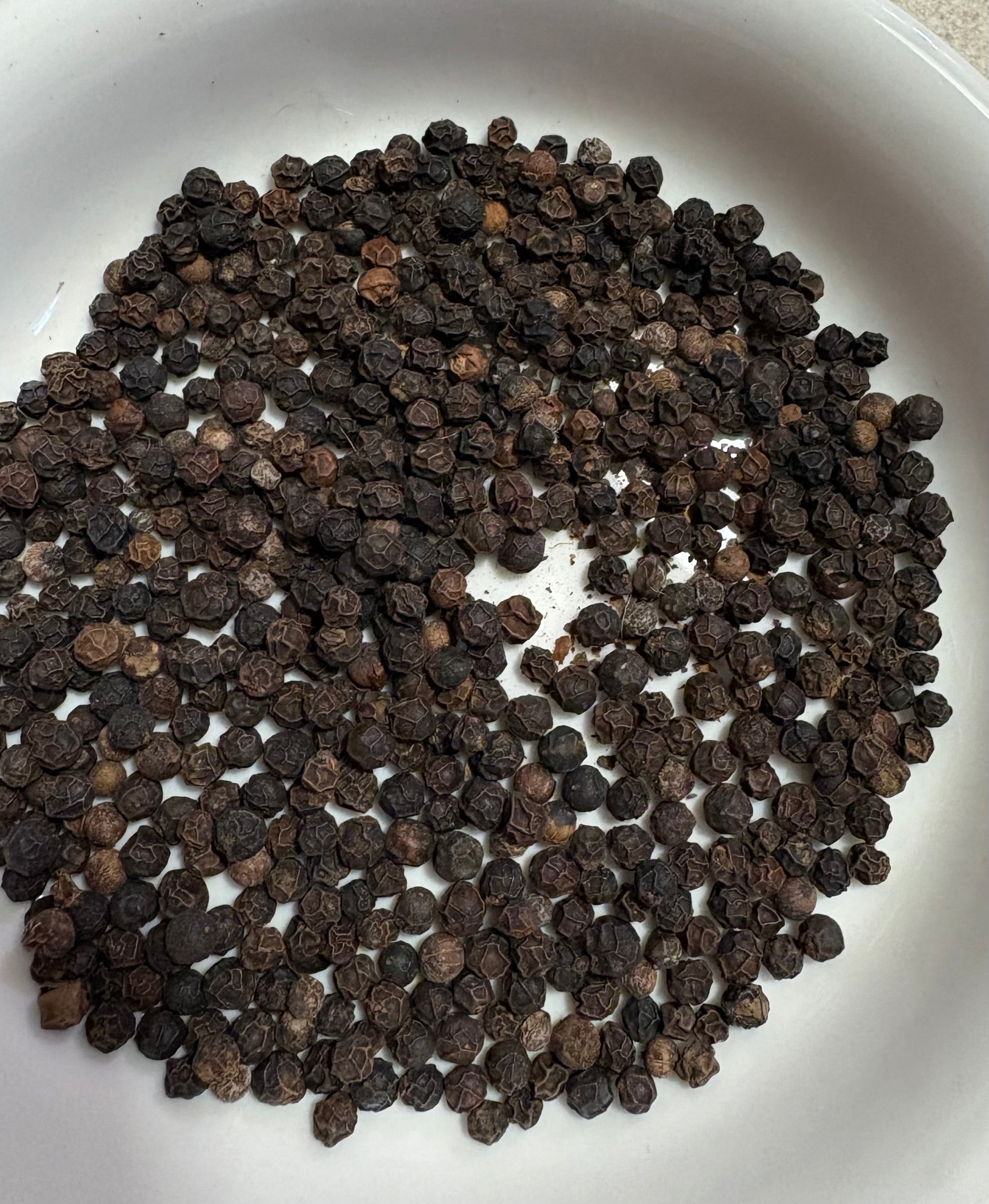 Whole black peppercorns used in Mehra Cup turmeric tea blend