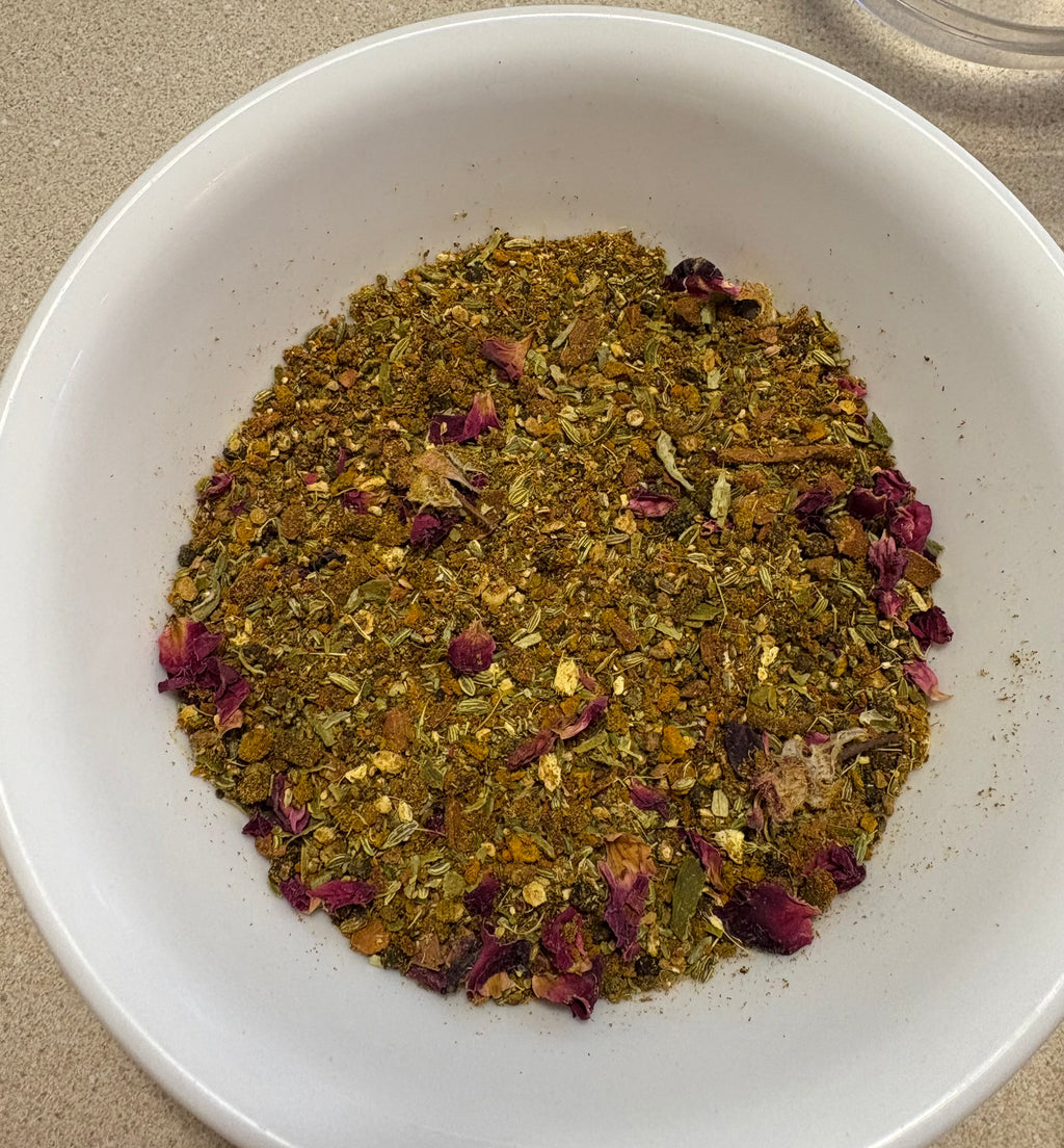 Close-up of Mehra Cup caffeine-free turmeric tea blend with dried rose petals and spices